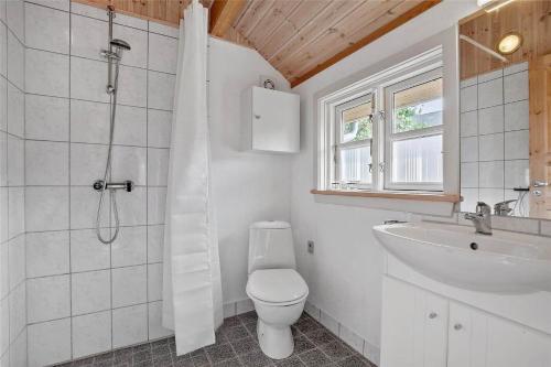 a bathroom with a shower and a toilet and a sink at SL283-Slagelse-Havesangervej-2 in Slagelse