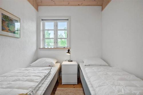 two beds in a room with white walls and a window at SL283-Slagelse-Havesangervej-2 in Slagelse