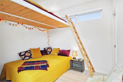 a bedroom with a yellow bed and a ladder at SL287-Slagelse-Strandvaenget-14 in Slagelse