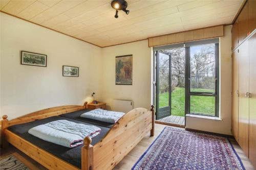 a bedroom with a bed and a large window at SL122-Slagelse-Delfivej-6 in Slagelse