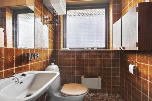 a bathroom with a white toilet and a sink at SL122-Slagelse-Delfivej-6 in Slagelse