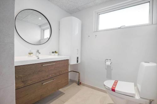 a bathroom with a sink and a mirror and a toilet at SL301-Korsor-Strandengen-1 in Korsør