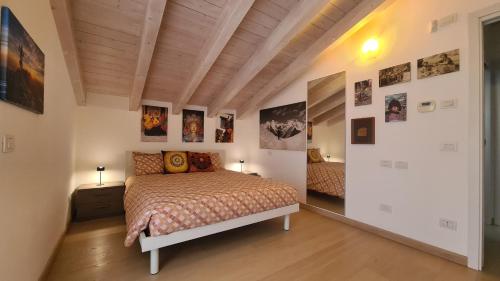 a bedroom with a bed and pictures on the walls at Namastè in Mandello del Lario