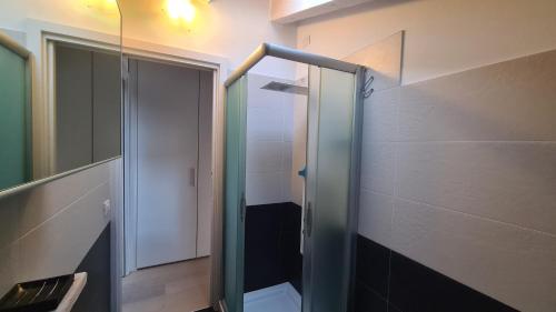 a bathroom with a glass shower with a toilet at Namastè in Mandello del Lario