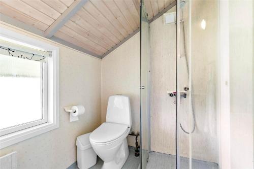 a bathroom with a toilet and a glass shower at K20031-Kalundborg-Kystagervej-29 in Kalundborg