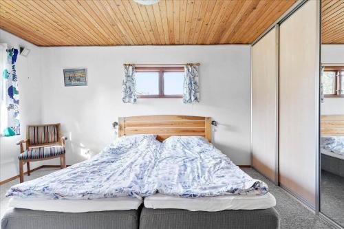 a bedroom with a bed and a wooden ceiling at K20061-Gorlev-Eranthisvej-7 in Gørlev