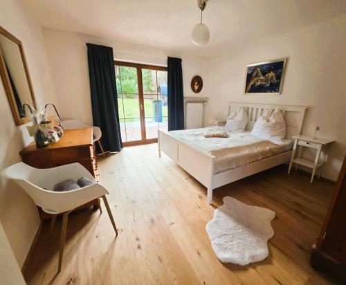 a bedroom with a bed and a desk and a chair at Chalet Anna in Unterwössen