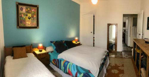 a bedroom with two beds and two candles on tables at La Ptite Fabrique chez Malot in Montceau-les-Mines
