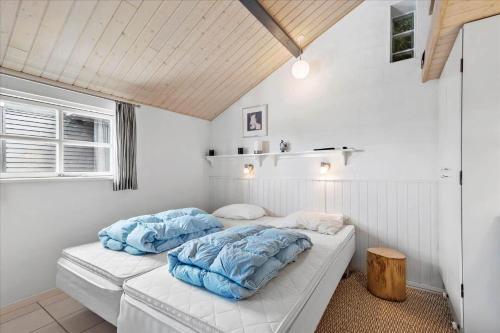 a bed in a room with two pillows on it at SL216-Slagelse-Bildsovej-117 in Slagelse