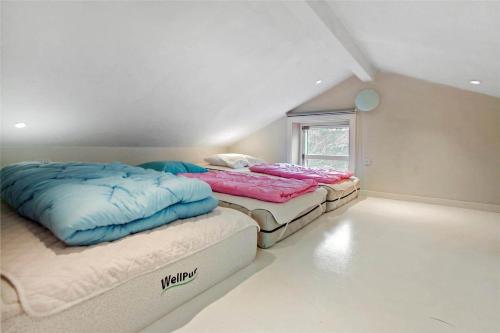 two twin beds in a room with a window at SL245-Rude-Fuglevaenget-20 in Rude