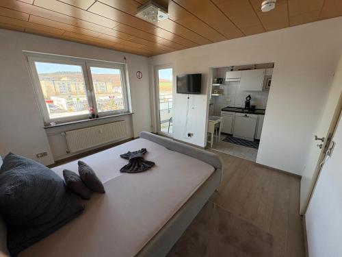 a large couch in a room with a kitchen at Steffies Apartment two in Idstein