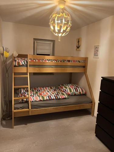 a bedroom with two bunk beds and a chandelier at Little Rostock in Papendorf