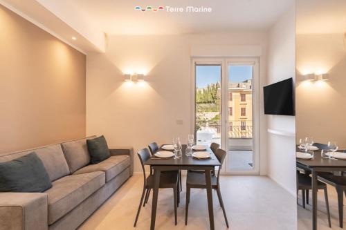a living room with a couch and a table at Suite Level 8, Terre Marine in La Spezia