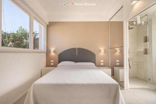 a bedroom with a large bed and a window at Suite Level 8, Terre Marine in La Spezia