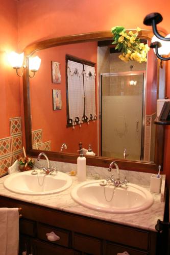 a bathroom with two sinks and a large mirror at El Trebano in Cardes