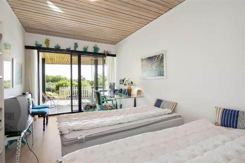 a bedroom with two beds and a balcony at K19016-Kalundborg-Klintedalsvej-37 in Kalundborg