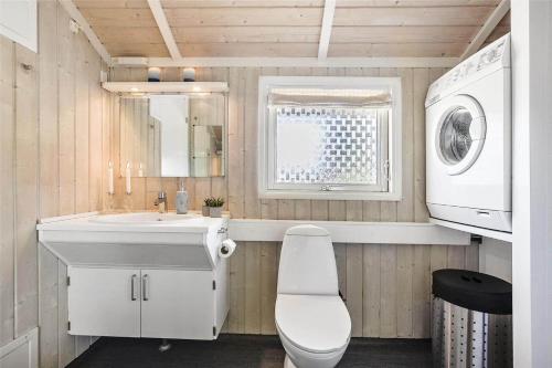 a bathroom with a sink and a washing machine at SL256-Skaelskor-Ostre-Strand-115 in Skælskør