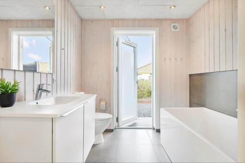 a bathroom with a tub and a toilet and a sink at SL296-Slagelse-Athenesvej-7 in Slagelse