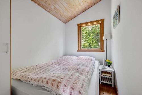a white bedroom with a bed and a window at SL347-Korsor-Tvaerager-9 in Korsør