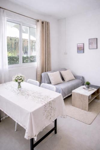 a living room with a table and a couch at Yada House s&s in Nai Yang Beach
