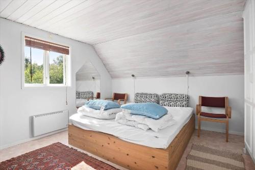 a bedroom with a large bed with blue pillows at SKA580-Perstorp-Oerahult-708 in Perstorp
