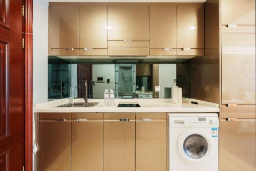 a kitchen with a sink and a washing machine at Shanghai Little 8 Apartment in Shanghai