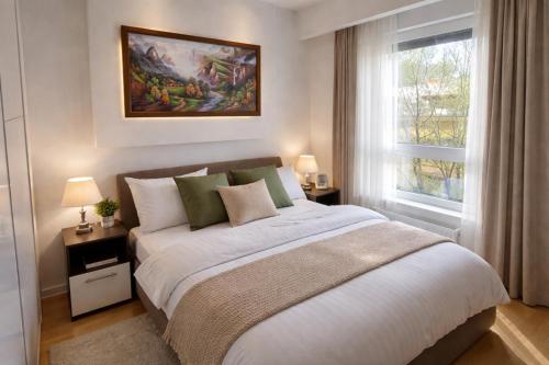 a bedroom with a large bed and a window at Extra Apartman in Banja Luka