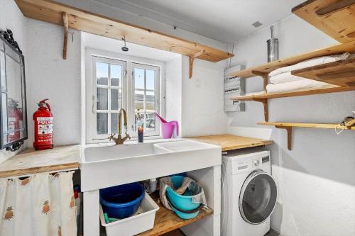 a kitchen with a sink and a washing machine at SL349-Slagelse-Kongsmarkvej-259 in Slagelse
