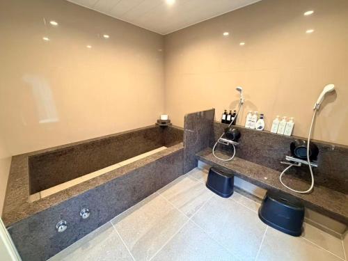 a bathroom with a sink and a large tub at Izu Plateau House 420 square meters, BBQ , 8 bedrooms, 1 living room 1kitchen 6 toilets 4 bathroom 1 onsen in Yawatano