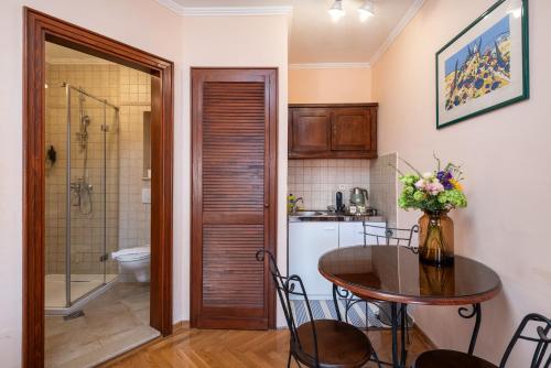 a kitchen with a table and a bathroom at Antaeus Old Town Residence in Dubrovnik