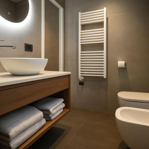 a bathroom with a sink and a toilet at Hotel Miramare in Sottomarina