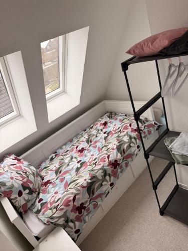 a bed in a room with a flower patterned mattress at Yunis Landhaus in Grömitz