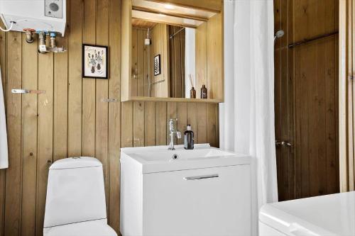 a bathroom with a white sink and a toilet at 20315-Samso-Rosenvej-42 in Tanderup