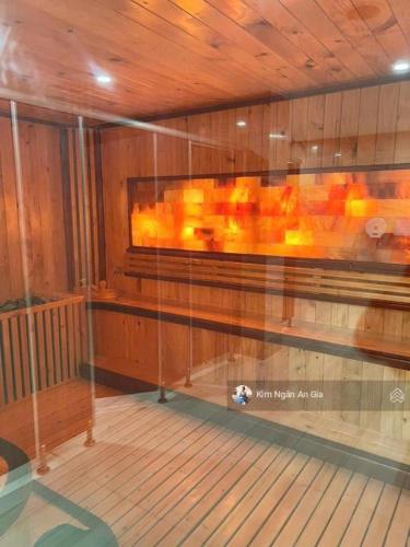 a room with a wooden ceiling and a glass wall at Căn hộ 2PN THE EMERALD GOLF VIEW in Thuan An
