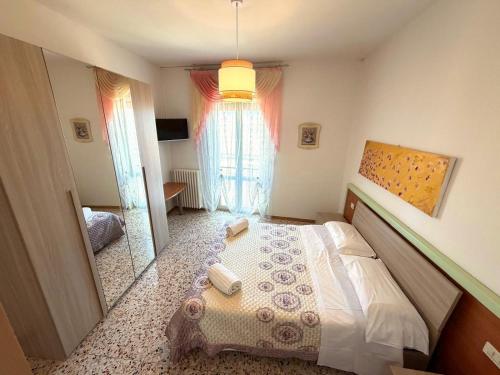 a bedroom with a large bed and a mirror at Hotel San Donnino in Fidenza