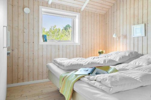 two beds in a room with a window at 20134-Samso-Heden-19 in Nordby