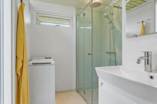 a bathroom with a sink and a shower at 20119-Samso-Maarup-Skov-26 in Nordby