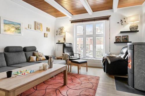 a living room with a couch and a table at 20120-Samso-Nordby-Hovedgade-22 in Nordby