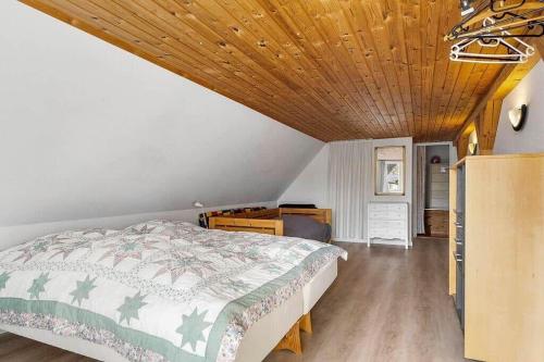 a bedroom with a bed and a wooden ceiling at 20120-Samso-Nordby-Hovedgade-22 in Nordby