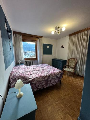 a hotel room with a bed and a window at Calvi's Center Home in Auronzo di Cadore