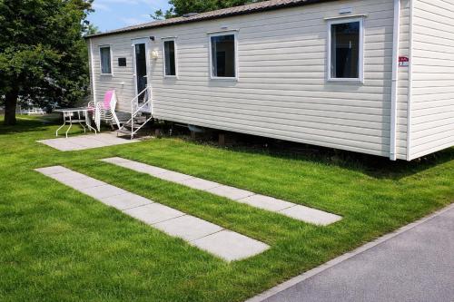 a house with a table and chairs in a yard at Rockley Park, Poole, 3 Bedroom Family Retreat in Poole in Poole