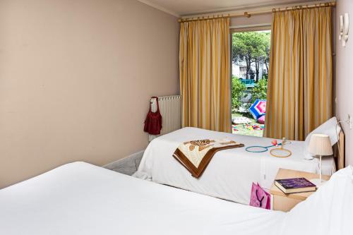 a room with two beds and a window at Villetta Dino in Vada