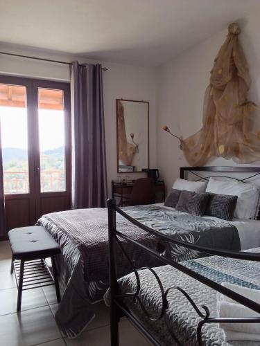 a bedroom with two beds and a window at Petra & Elato Art Hotel in Valtessiniko