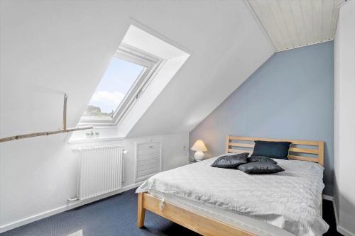 a bedroom with a bed and a window at 20212-Samso-Saelvig-50 in Sælvig
