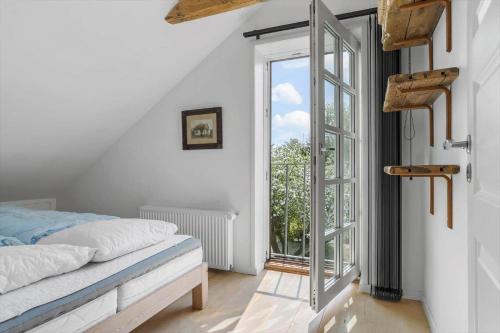 a bedroom with a bed and an open door at 20310-Ballen-Strandvejen-8 in Ballen