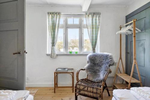 a living room with a chair and a window at 20322-Samso-Bakkevej-7 in Brundbymark