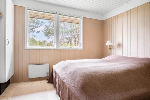 a bedroom with a large bed and two windows at 20209-Samso-Rosenvej-21 in Tanderup
