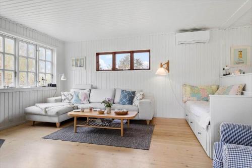 a living room with a couch and a table at 20132-Samso-Skovvejen-7 in Nordby