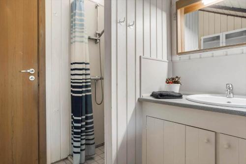 a bathroom with a shower curtain next to a sink at 20223-Samso-Rosenvej-8 in Tanderup