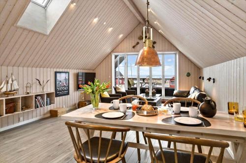a kitchen and dining room with a table and chairs at 20123-Samso-Maarup-Havn-7-A in Nordby